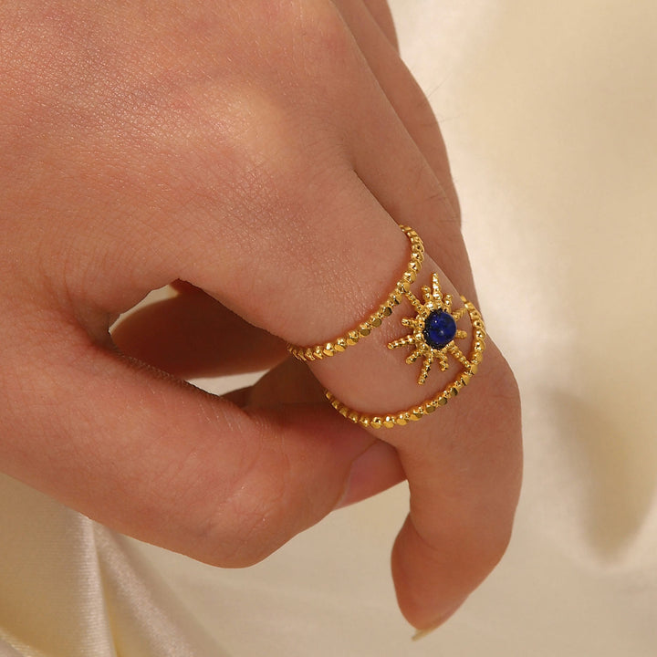 Anello con gemma a forma di stella a otto punte e doppia fila di girasole Olivenorma