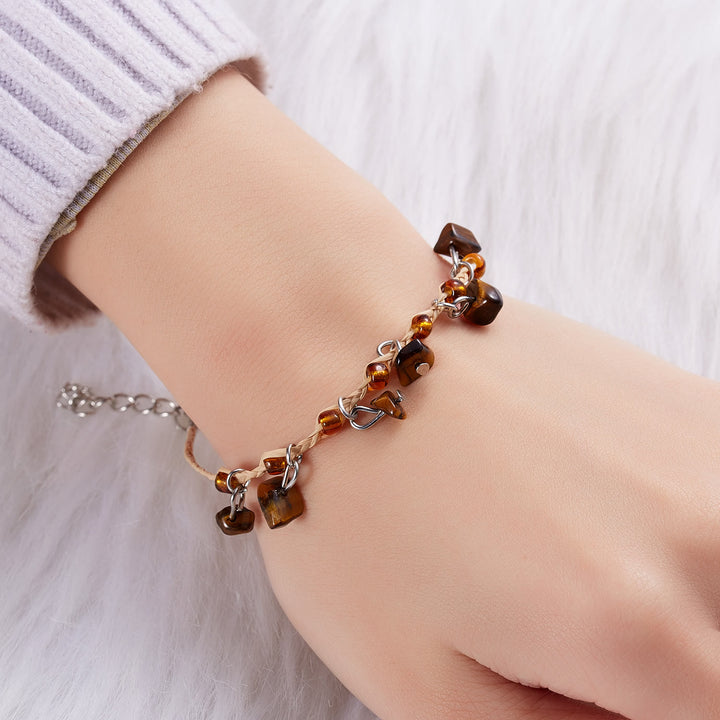 Bracciale intrecciato con ghiaia, nappa, ossidiana, occhio di tigre e ametista Olivenorma