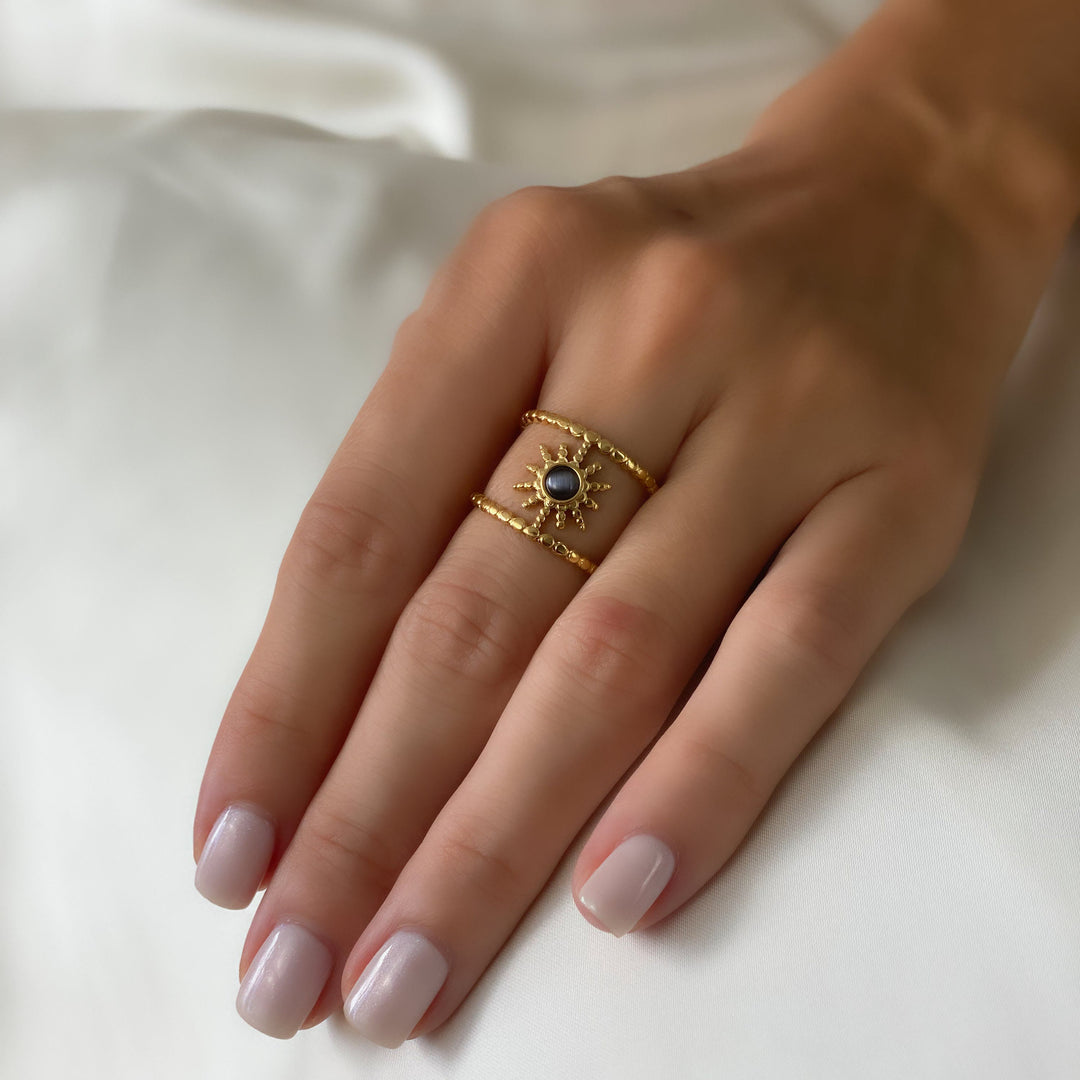 Anello con gemma a forma di stella a otto punte e doppia fila di girasole Olivenorma