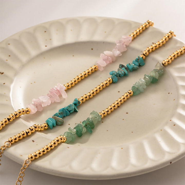 Bracciale Olivenorma con perline dorate in cristalli naturali frantumati