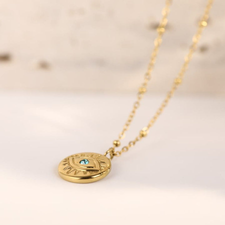 Collana in acciaio al titanio 316L con topazio blu e malocchio Olivenorma 