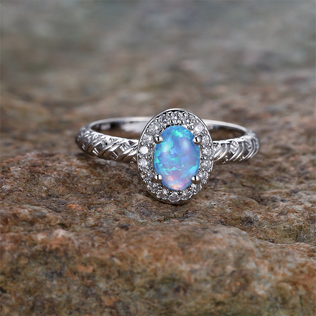 Anello con motivo a corda intrecciata con bordo ovale in opale Olivenorma