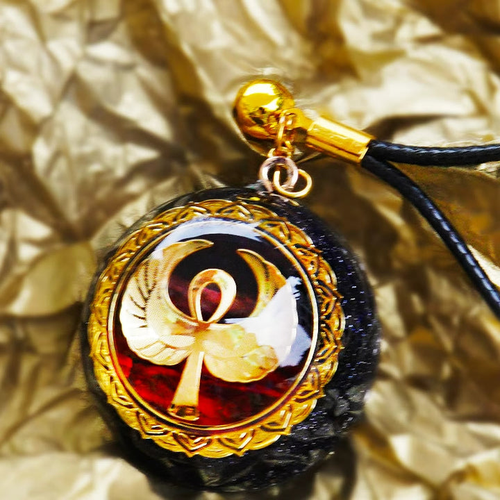 Collana Olivenorma in arenaria blu, agata rossa e OM Orgone