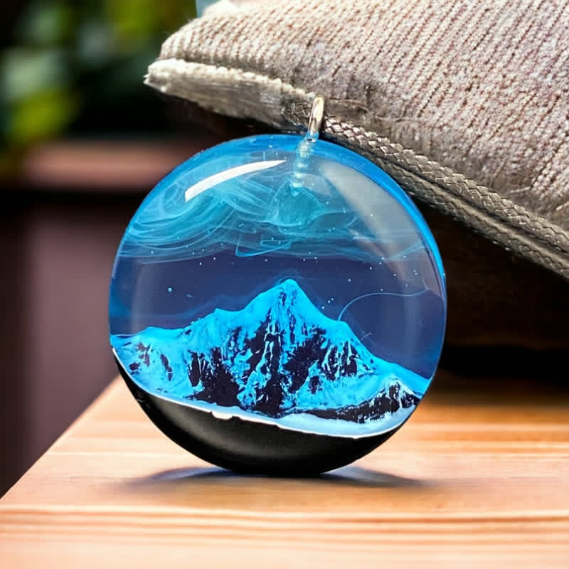 Collana con ciondolo rotondo in resina con montagna innevata blu Olivenorma