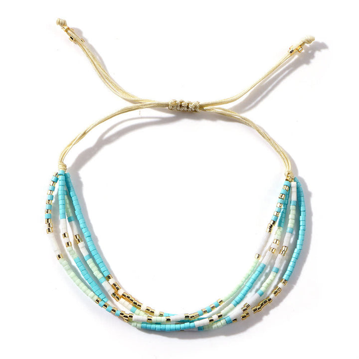 Olivenorma Braccialetto da spiaggia intrecciato con perline di riso bianco e blu 