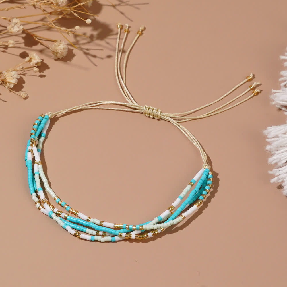 Olivenorma Braccialetto da spiaggia intrecciato con perline di riso bianco e blu 