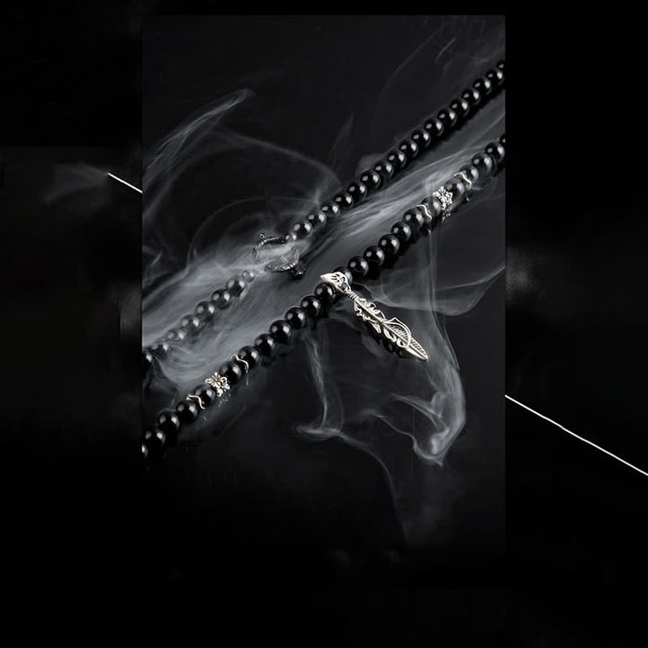 Olivenorma Collana con ciondolo in piuma di metallo con perle di ossidiana da 6 mm