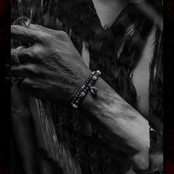 Bracciale Olivenorma con ciondolo a forma di artiglio del diavolo in perline di ossidiana d'argento 