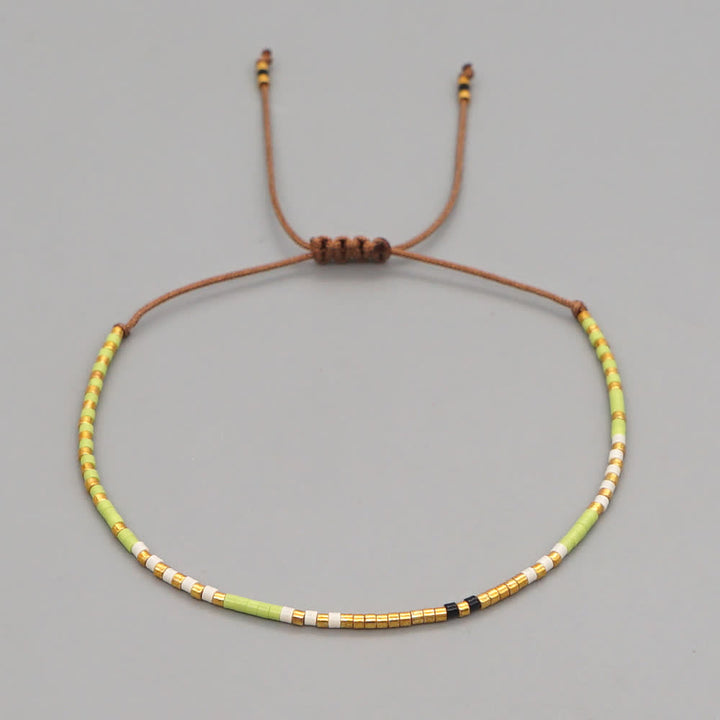 Olivenorma Braccialetto con coulisse marrone con perline di riso colorate 