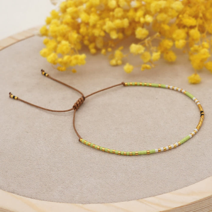 Olivenorma Braccialetto con coulisse marrone con perline di riso colorate 