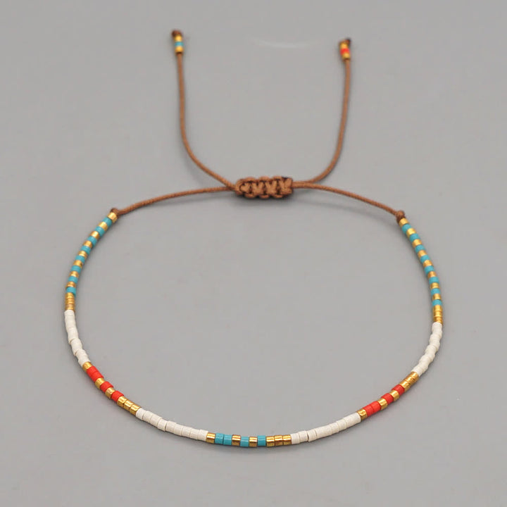 Olivenorma Braccialetto intrecciato marrone con perline di riso colorate 