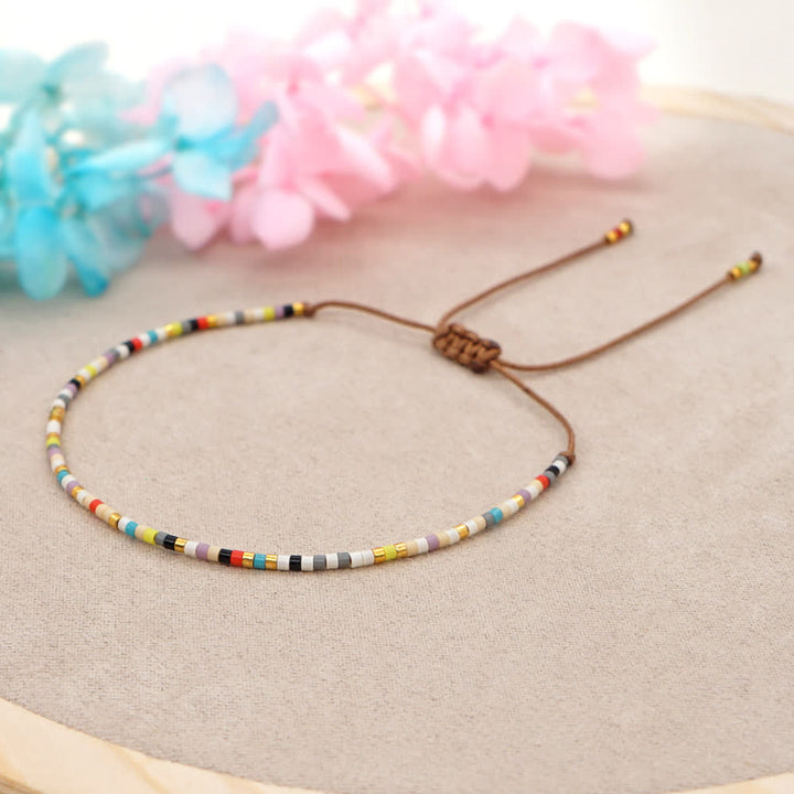 Olivenorma Braccialetto intrecciato marrone con perline di riso colorate 