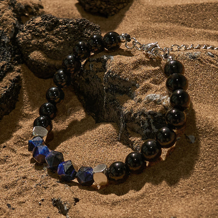 Bracciale Olivenorma in perline di ossidiana blu sfaccettata con occhio di tigre