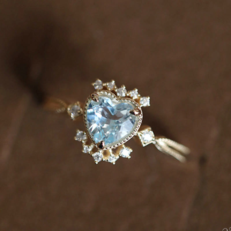 Anello Olivenorma con topazio blu naturale e zircone bianco