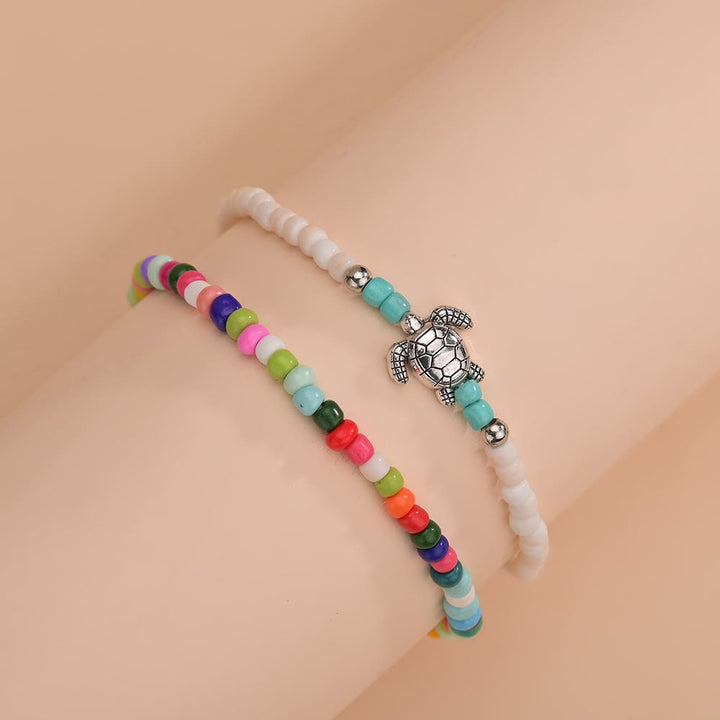 Olivenorma 2 pezzi cavigliera tartaruga con perline colorate bianche