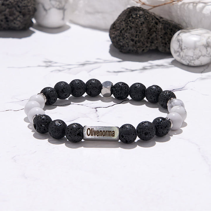 Bracciale Olivenorma in pietra lavica con perline turchesi bianche incise