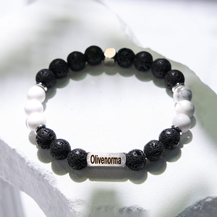 Bracciale Olivenorma in pietra lavica con perline turchesi bianche incise