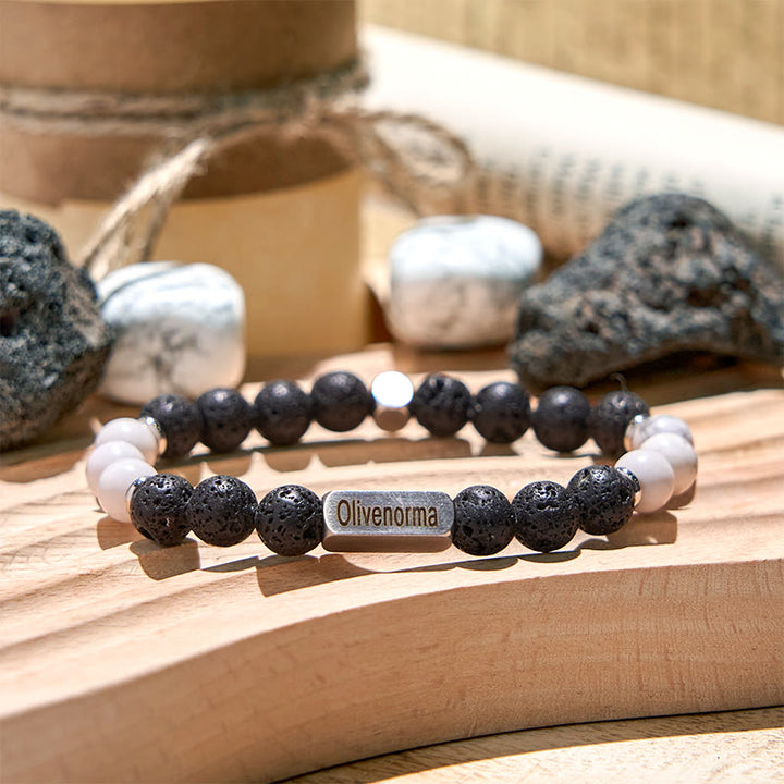 Bracciale Olivenorma in pietra lavica con perline turchesi bianche incise