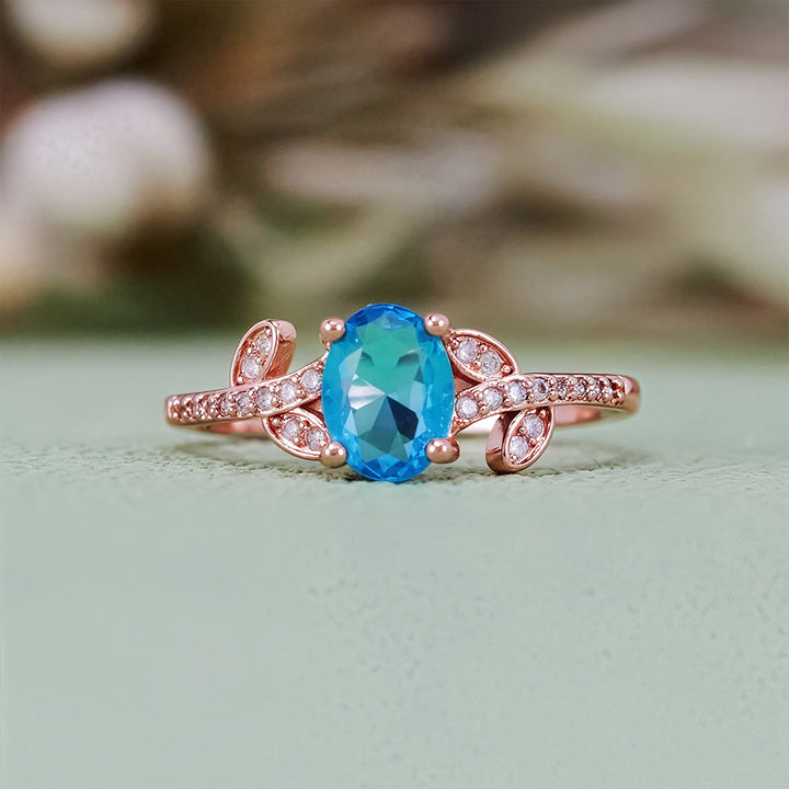 Anello Olivenorma con topazio blu ovale avvolto a foglia