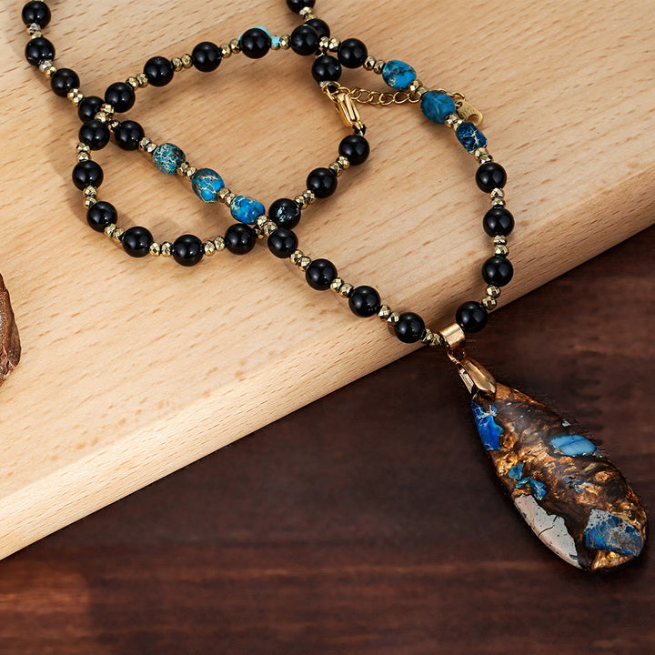 Collana con ciondolo in pietra blu dell'imperatore con perline di ossidiana Olivenorma