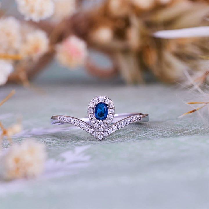 Anello Olivenorma con corona a goccia e topazio blu