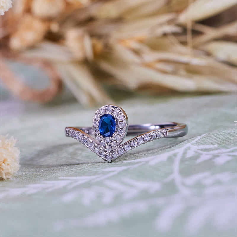 Anello Olivenorma con corona a goccia e topazio blu
