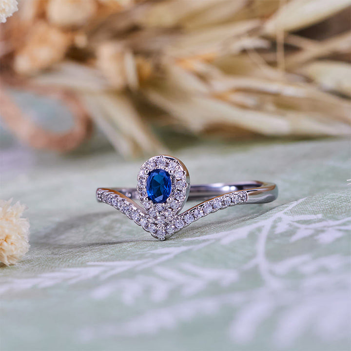 Anello Olivenorma con corona a goccia e topazio blu