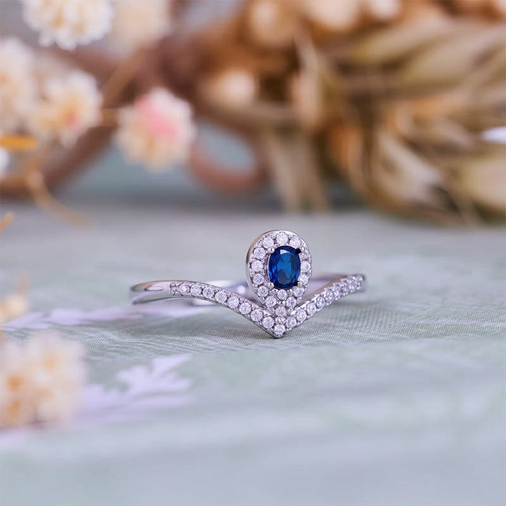 Anello Olivenorma con corona a goccia e topazio blu