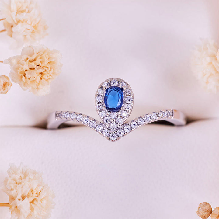 Anello Olivenorma con corona a goccia e topazio blu