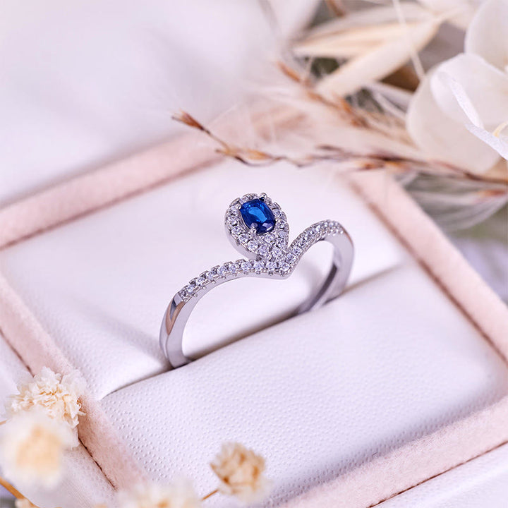 Anello Olivenorma con corona a goccia e topazio blu