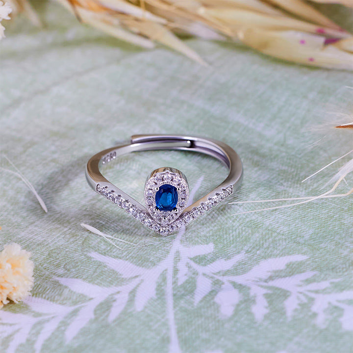 Anello Olivenorma con corona a goccia e topazio blu