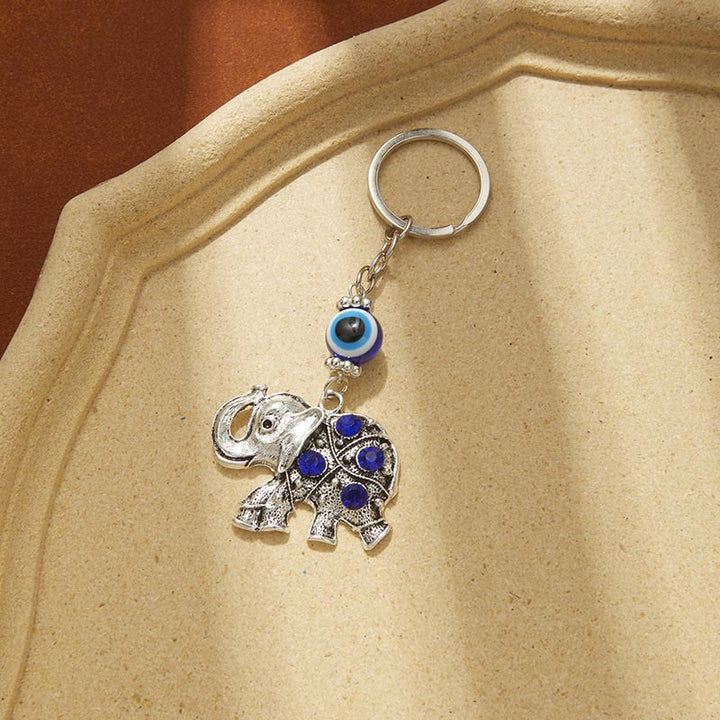 Portachiavi creativo Olivenorma con occhio malvagio blu e dettagli di animali/piante - Elefante - image 7
