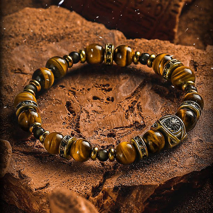 Bracciale Olivenorma con perline incise in occhio di tigre e ossidiana dorata con simbolo del sole. - image 1
