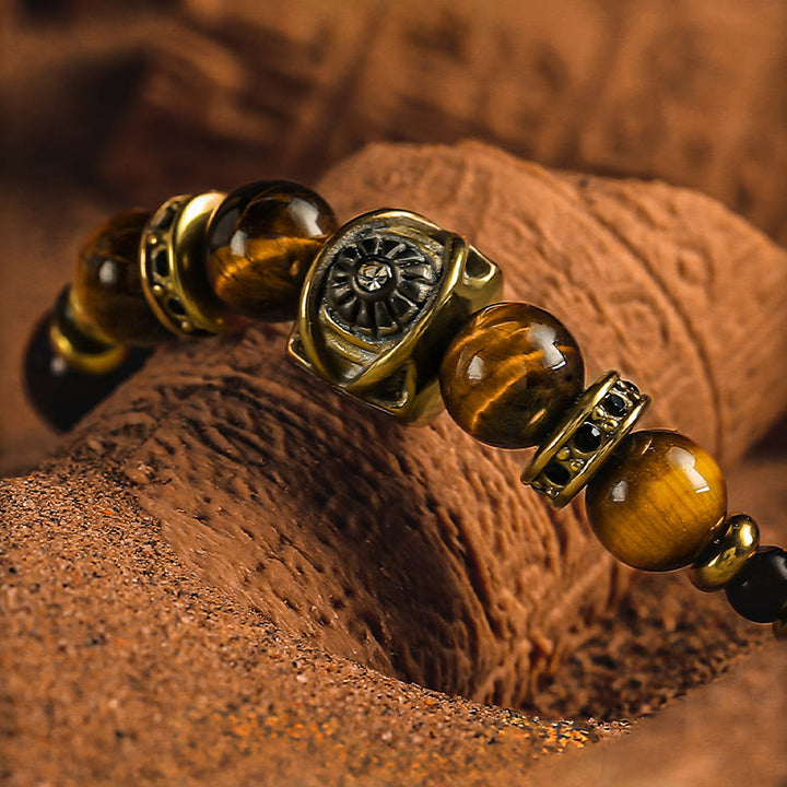 Bracciale Olivenorma con perline incise in occhio di tigre e ossidiana dorata con simbolo del sole. - image 2