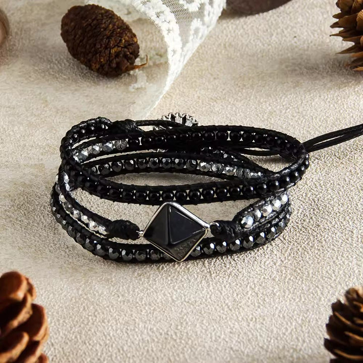 Bracciale avvolgente intrecciato a mano Olivenorma con simbolo energetico e magnete occhio di tigre naturale. - Nero - image 2