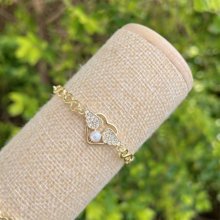 Bracciale Olivenorma in rame con ciondolo a forma di occhio di Allah e simbolo di protezione. - Ciondolo a forma di cuore con ala e perla - image 6