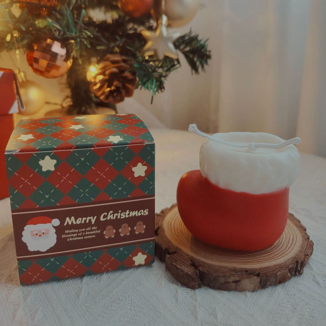 Candela di Natale con calzino a forma di palla di filato per guanto inciso Olivenorma 