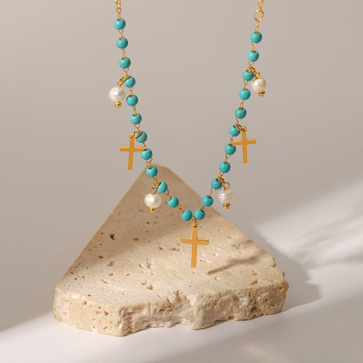 Collana con ciondolo a croce con perle turchesi Olivenorma e nappa