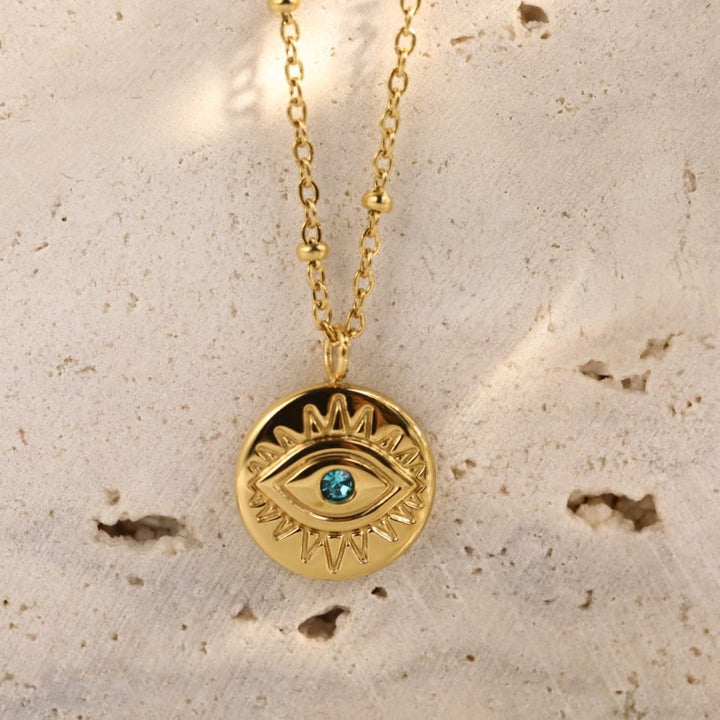 Collana in acciaio al titanio 316L con topazio blu e malocchio Olivenorma 