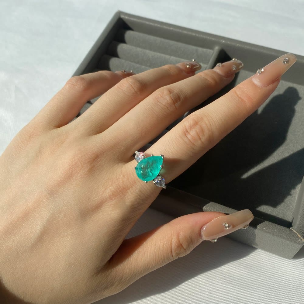 Anello squisito con tormalina Paraiba Olivenorma e zircone bianco
