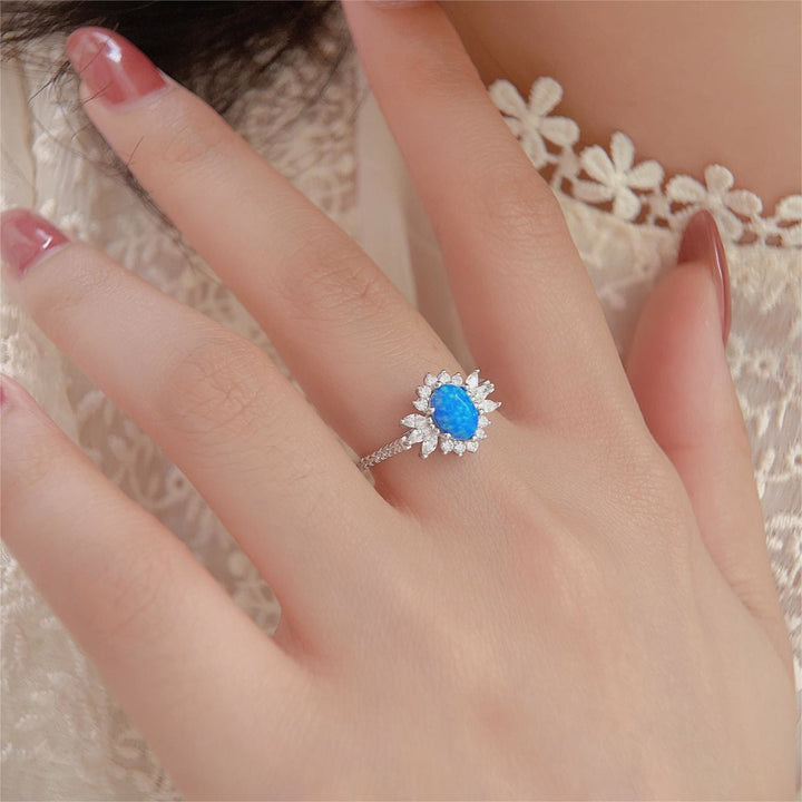 Anello Olivenorma in argento 925 con design a girasole bianco e blu opale 