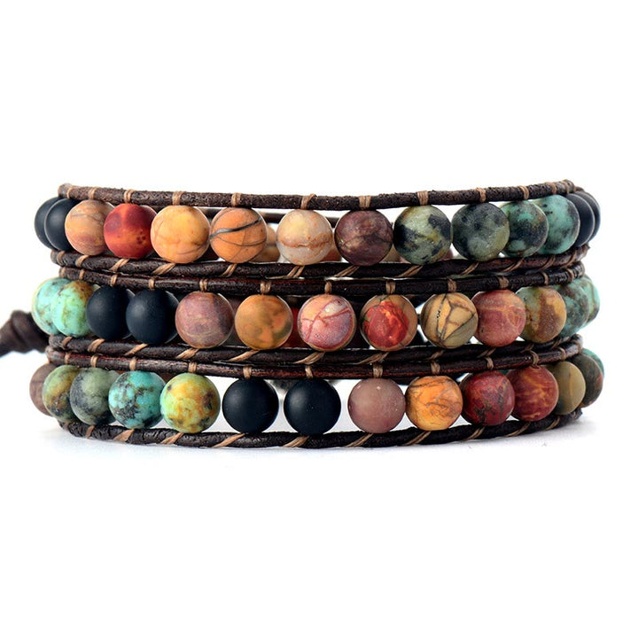 Bracciale avvolgente in pelle intrecciata a mano con perline color turchese satinato