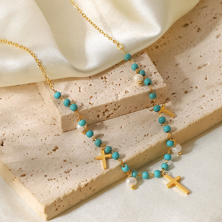 Collana con ciondolo a croce con perle turchesi Olivenorma e nappa