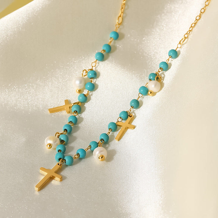 Collana con ciondolo a croce con perle turchesi Olivenorma e nappa