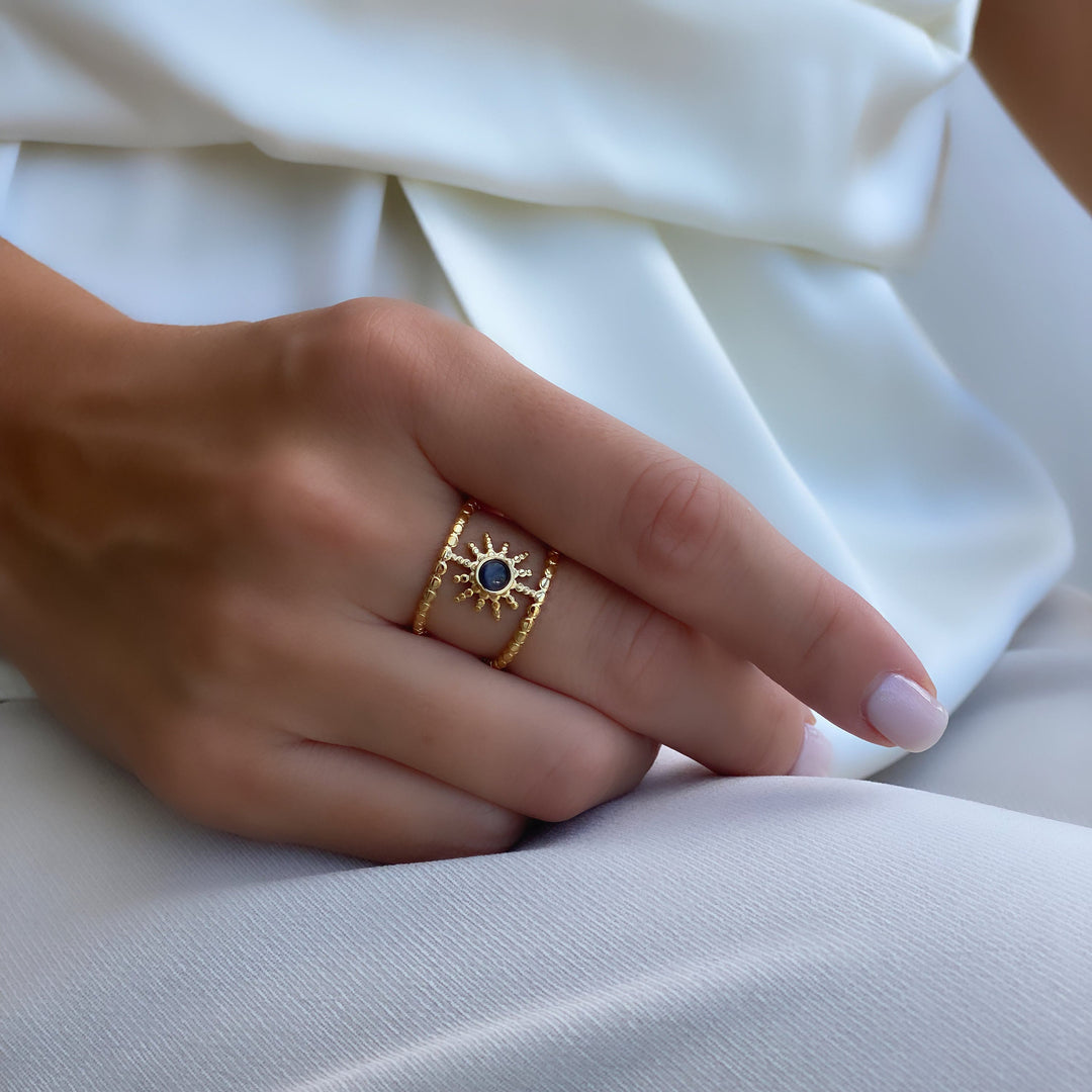 Anello con gemma a forma di stella a otto punte e doppia fila di girasole Olivenorma