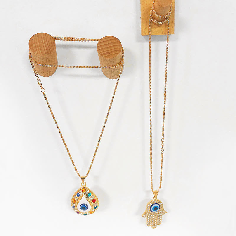 Collana con ciondolo a forma di catena con zircone HAMSA e occhio malvagio