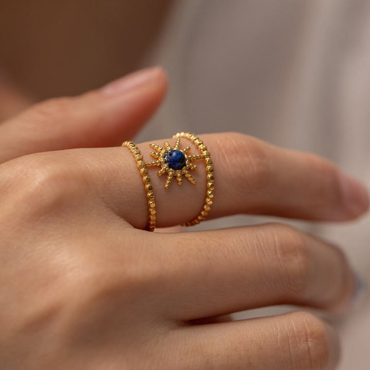Anello con gemma a forma di stella a otto punte e doppia fila di girasole Olivenorma