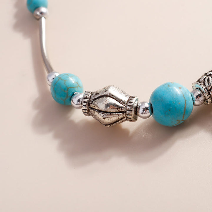 Bracciale con ciondolo a croce con perline turchesi Olivenorma