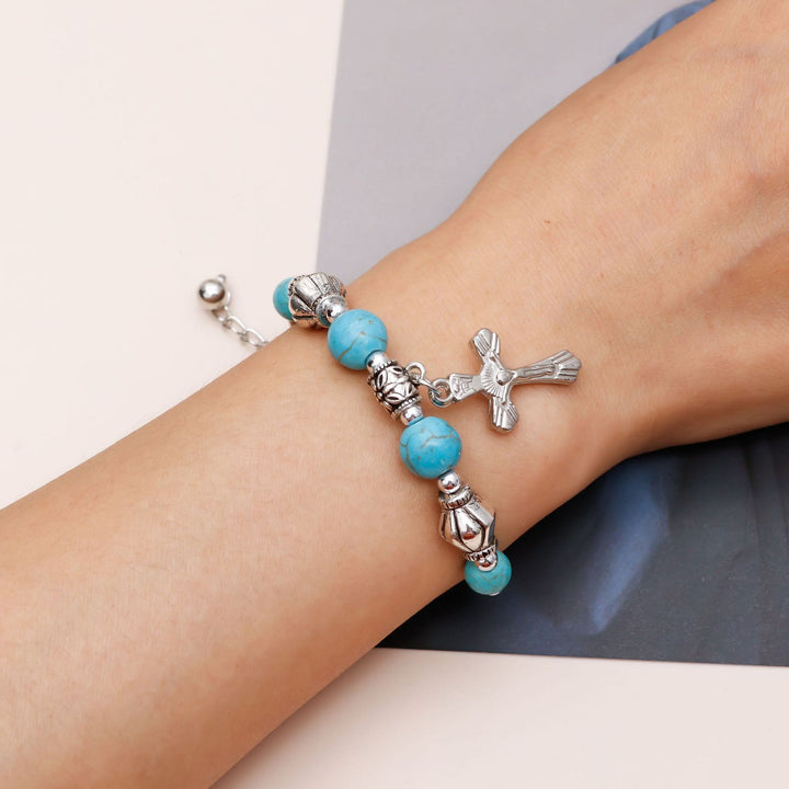Bracciale con ciondolo a croce con perline turchesi Olivenorma