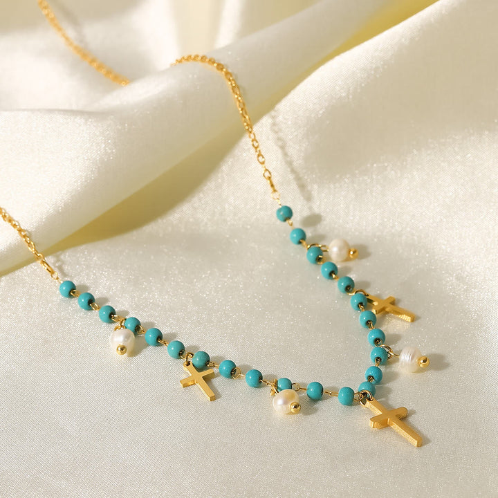 Collana con ciondolo a croce con perle turchesi Olivenorma e nappa